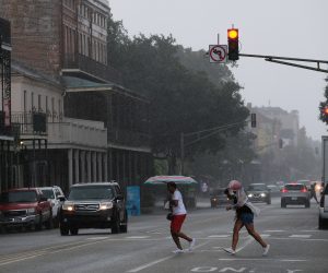 epa07713278 People run from the rain in the French Quarter as Tropical Storm Barry approaches in New Orleans, Louisiana, USA, on 12 July 2019. Tropical Storm Barry is predicted to make landfall as a Category 1 hurricane.  EPA/DAN ANDERSON