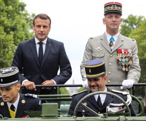 epa07715842 France's President Emmanuel Macron (L) stands in an Acmat VLRA vehicle next to French Armies Chief Staff General Francois Lecointre as they review troops before the start of the Bastille Day military parade down the Champs-Elysees avenue in Paris, France, 14 July 2019.  EPA/LUDOVIC MARIN / POOL  MAXPPP OUT