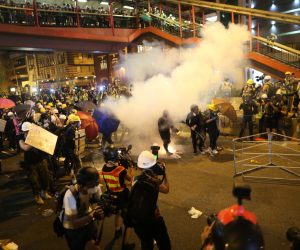 epa07731558 Riot police shoot tear gas while anti-extradition bill protesters take part in a rally in Hong Kong, China, 21 July 2019. The organizer of the march, the Civil Human Rights Front, is urging the government to set up an independent commission of inquiry to be led by a judge, to look into the policing of recent extradition protests. The Front originally planned to march from Victoria Park to the Court of Final Appeal in Central but the police said the march must end in Wan Chai instead for public safety reasons.  EPA/JEROME FAVRE