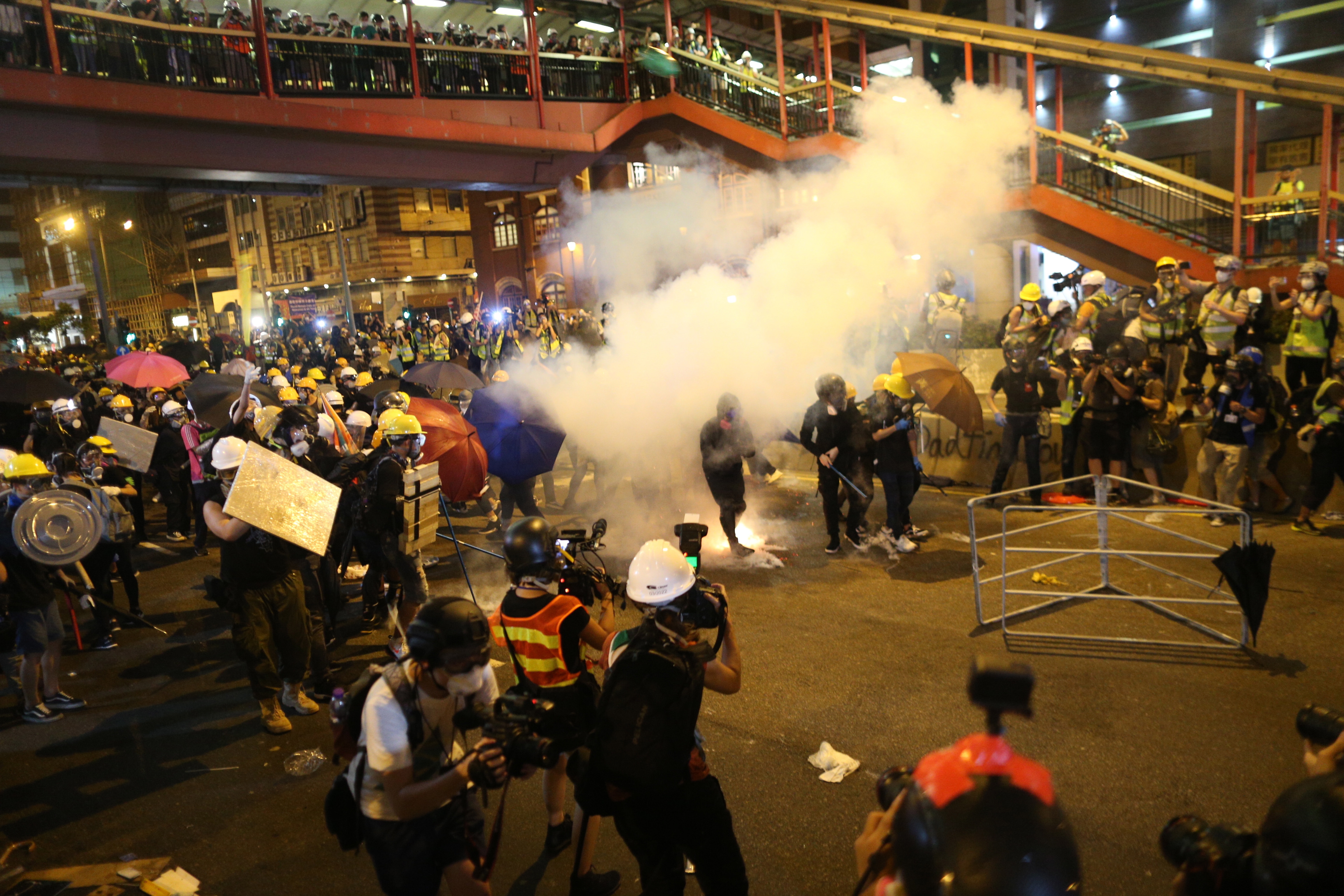 epa07731558 Riot police shoot tear gas while anti-extradition bill protesters take part in a rally in Hong Kong, China, 21 July 2019. The organizer of the march, the Civil Human Rights Front, is urging the government to set up an independent commission of inquiry to be led by a judge, to look into the policing of recent extradition protests. The Front originally planned to march from Victoria Park to the Court of Final Appeal in Central but the police said the march must end in Wan Chai instead for public safety reasons.  EPA/JEROME FAVRE
