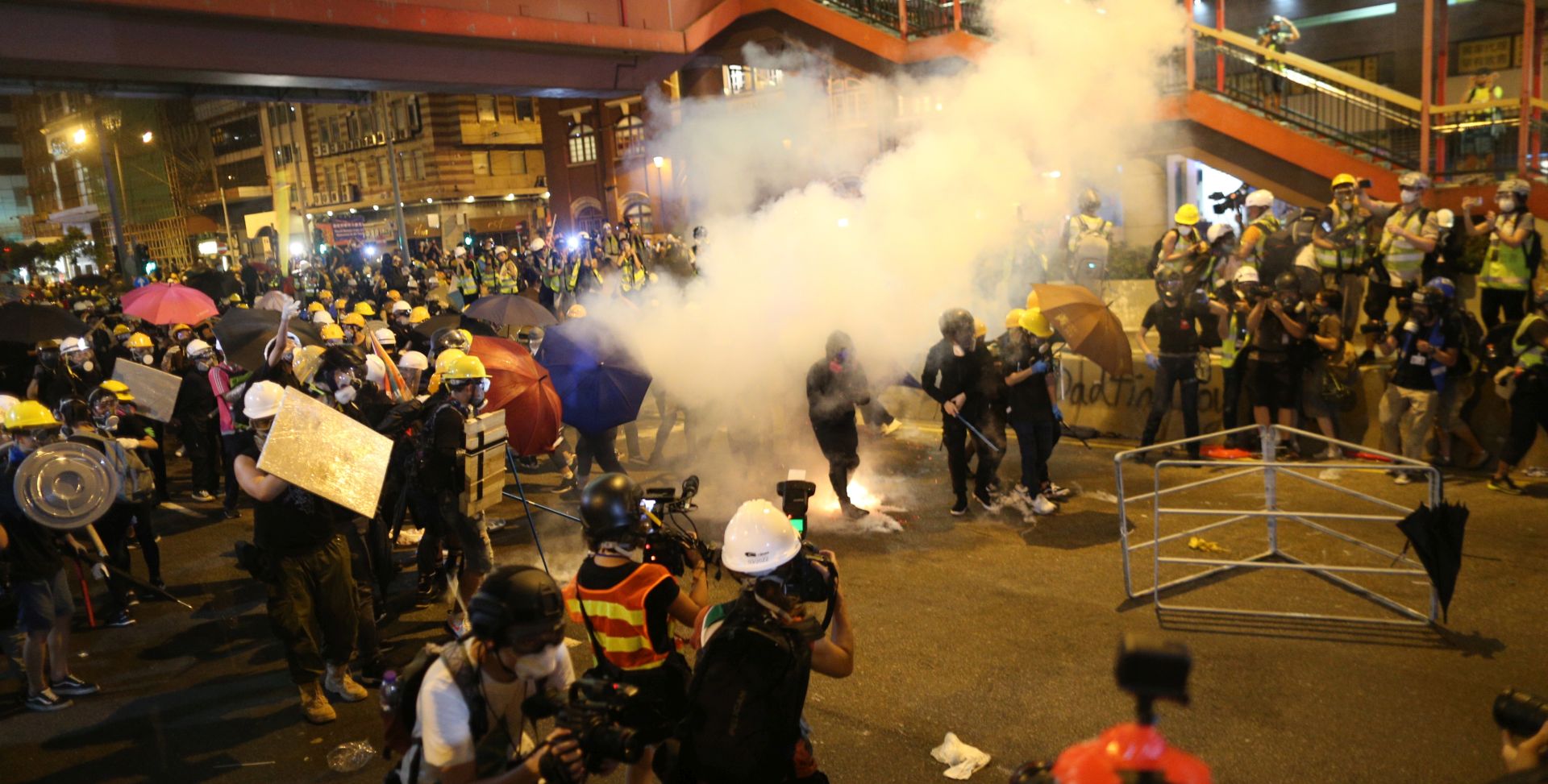epa07731558 Riot police shoot tear gas while anti-extradition bill protesters take part in a rally in Hong Kong, China, 21 July 2019. The organizer of the march, the Civil Human Rights Front, is urging the government to set up an independent commission of inquiry to be led by a judge, to look into the policing of recent extradition protests. The Front originally planned to march from Victoria Park to the Court of Final Appeal in Central but the police said the march must end in Wan Chai instead for public safety reasons.  EPA/JEROME FAVRE