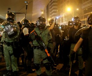 epa07731545 Riot police guard while anti-extradition bill protesters take part in a rally in Hong Kong, China, 21 July 2019. The organizer of the march, the Civil Human Rights Front, is urging the government to set up an independent commission of inquiry to be led by a judge, to look into the policing of recent extradition protests. The Front originally planned to march from Victoria Park to the Court of Final Appeal in Central but the police said the march must end in Wan Chai instead for public safety reasons.  EPA/JEROME FAVRE