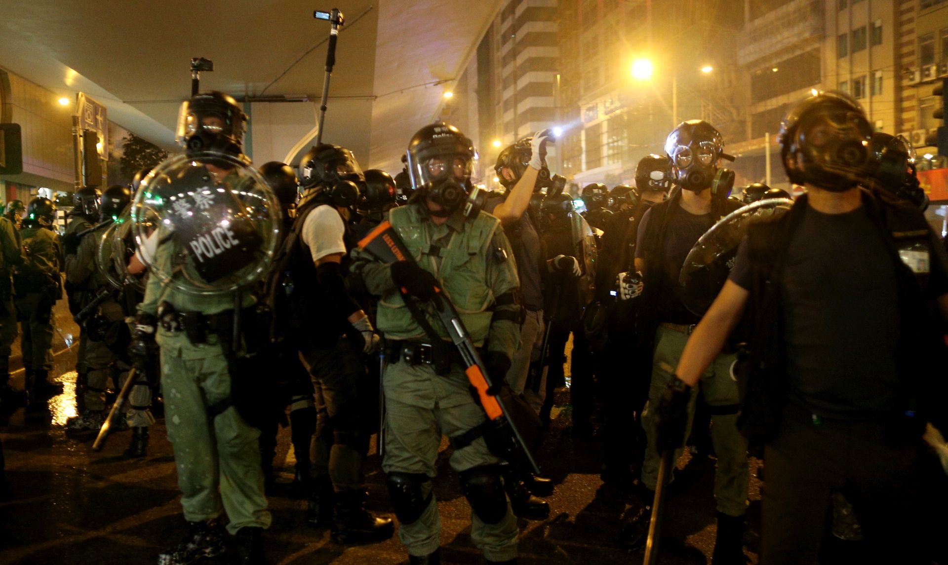 epa07731545 Riot police guard while anti-extradition bill protesters take part in a rally in Hong Kong, China, 21 July 2019. The organizer of the march, the Civil Human Rights Front, is urging the government to set up an independent commission of inquiry to be led by a judge, to look into the policing of recent extradition protests. The Front originally planned to march from Victoria Park to the Court of Final Appeal in Central but the police said the march must end in Wan Chai instead for public safety reasons.  EPA/JEROME FAVRE