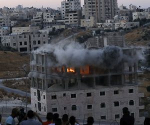 epa07733954 A Palestinian building is blown up by Israeli forces in the village of Sur Baher which sits on both sides of the Israeli barrier in East Jerusalem and the Israeli-occupied West Bank, 22 July 2019. Israeli authorities decided to demolish at least six Palestinian residential buildings housing lots of Palestinian families. The Israeli military announced the buildings were close to the West Bank separation barrier.  EPA/ABED AL HASHLAMOUN