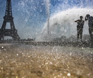 epa07735299 People cool down at the fountains of Trocadero, across from the Eiffel Tower, during a heatwave in Paris, France, 23 July 2019.  According to forecast, France will experience high temperatures across the country.  EPA/IAN LANGSDON