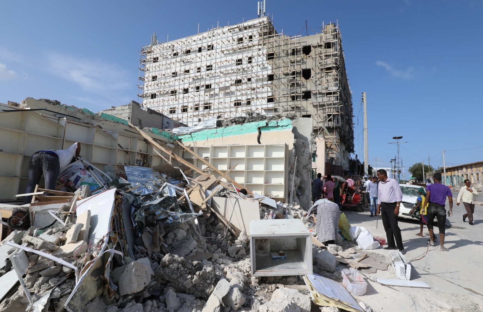 General view shows people at the scene of a suicide car explosion in Mogadishu A general view shows people at the scene of a suicide car explosion at a check point near Somali Parliament building in Mogadishu, Somalia June 15, 2019 REUTERS/Feisal Omar FEISAL OMAR