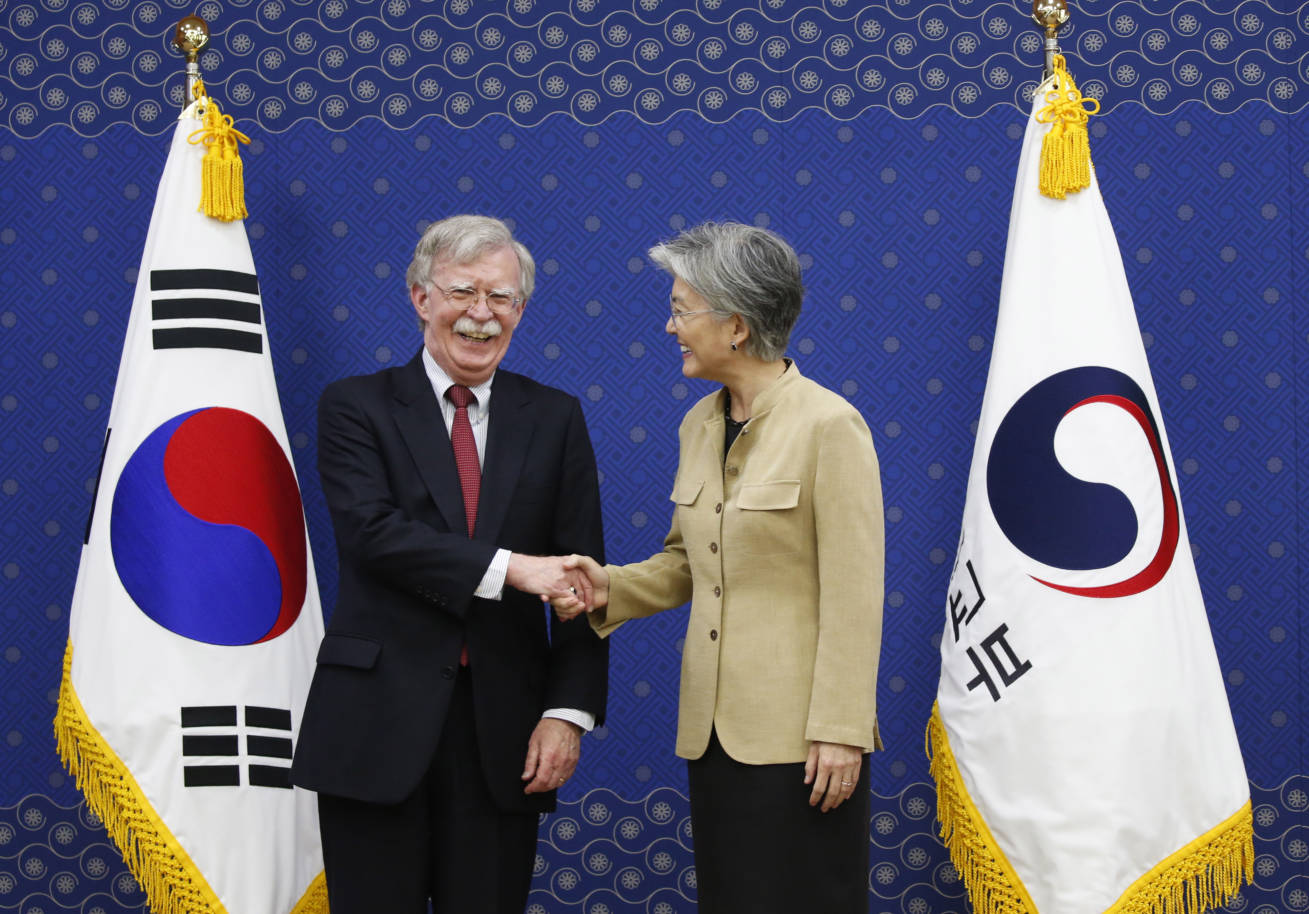 epa07736496 US National Security Adviser John Bolton (L) shakes hands with South Korean Foreign Minister Kang Kyung-wha (R) during their meeting at the foreign ministry building in Seoul, South Korea, 24 July 2019. John Bolton arrived in South Korea on a two-day visit to discuss ways to strengthen the South Korea-US alliance and resolve the situation on the Korean Peninsula.  EPA/KIM HEE-CHUL / POOL