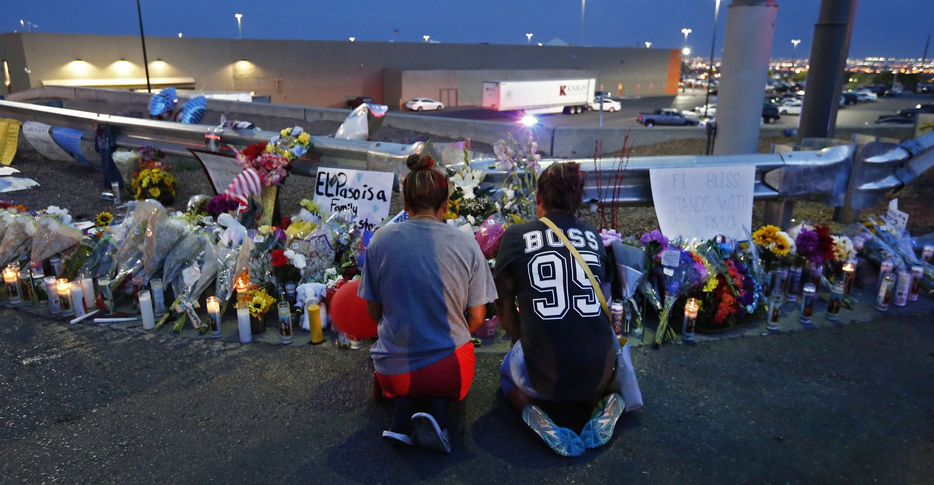 epa07757275 Two women kneel to pray at a make shift memorial at the site of a mass shooting at a Walmart in El Paso, Texas, USA, 04 August 2019. A day earlier, 20 people killed and 40 injured in a mass shooting at the Walmart in El Paso, Texa Prosecutors said that they will seek the death penalty against Patrick Crusiuss, a 21-year-old man, accused of the mass shooting.  EPA/LARRY W. SMITH
