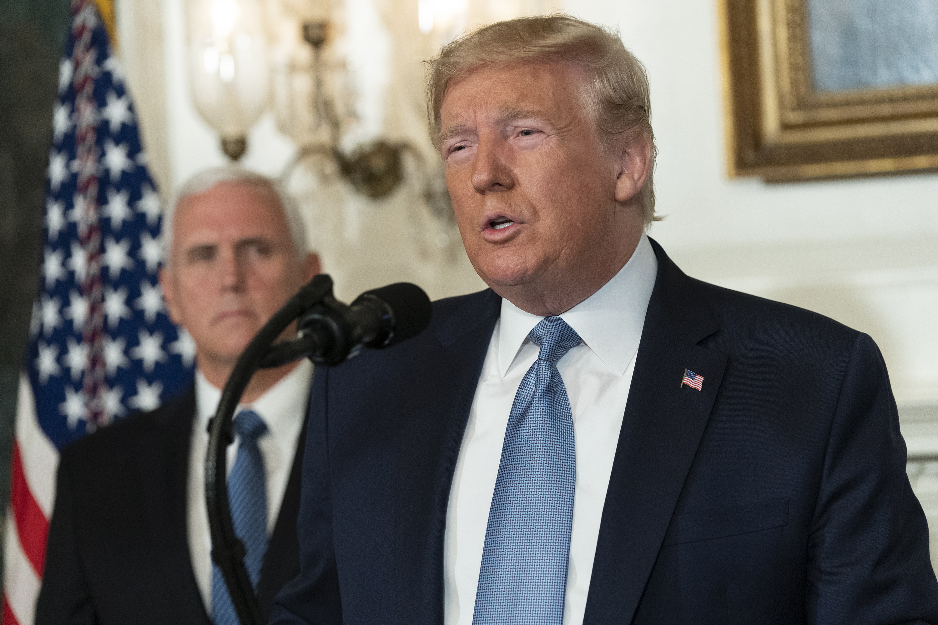 epa07757952 US President Donald J. Trump makes a statement at the White House in Washington, DC, USA, on 05 August 2019 in response to two separate shooting incidents. US Vice President Mike Pence looks on from left.  EPA/Chris Kleponis / POOL