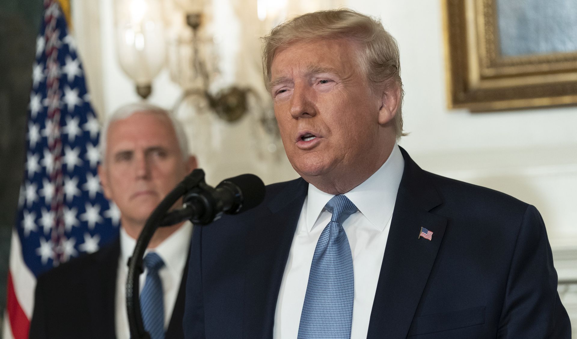 epa07757952 US President Donald J. Trump makes a statement at the White House in Washington, DC, USA, on 05 August 2019 in response to two separate shooting incidents. US Vice President Mike Pence looks on from left.  EPA/Chris Kleponis / POOL
