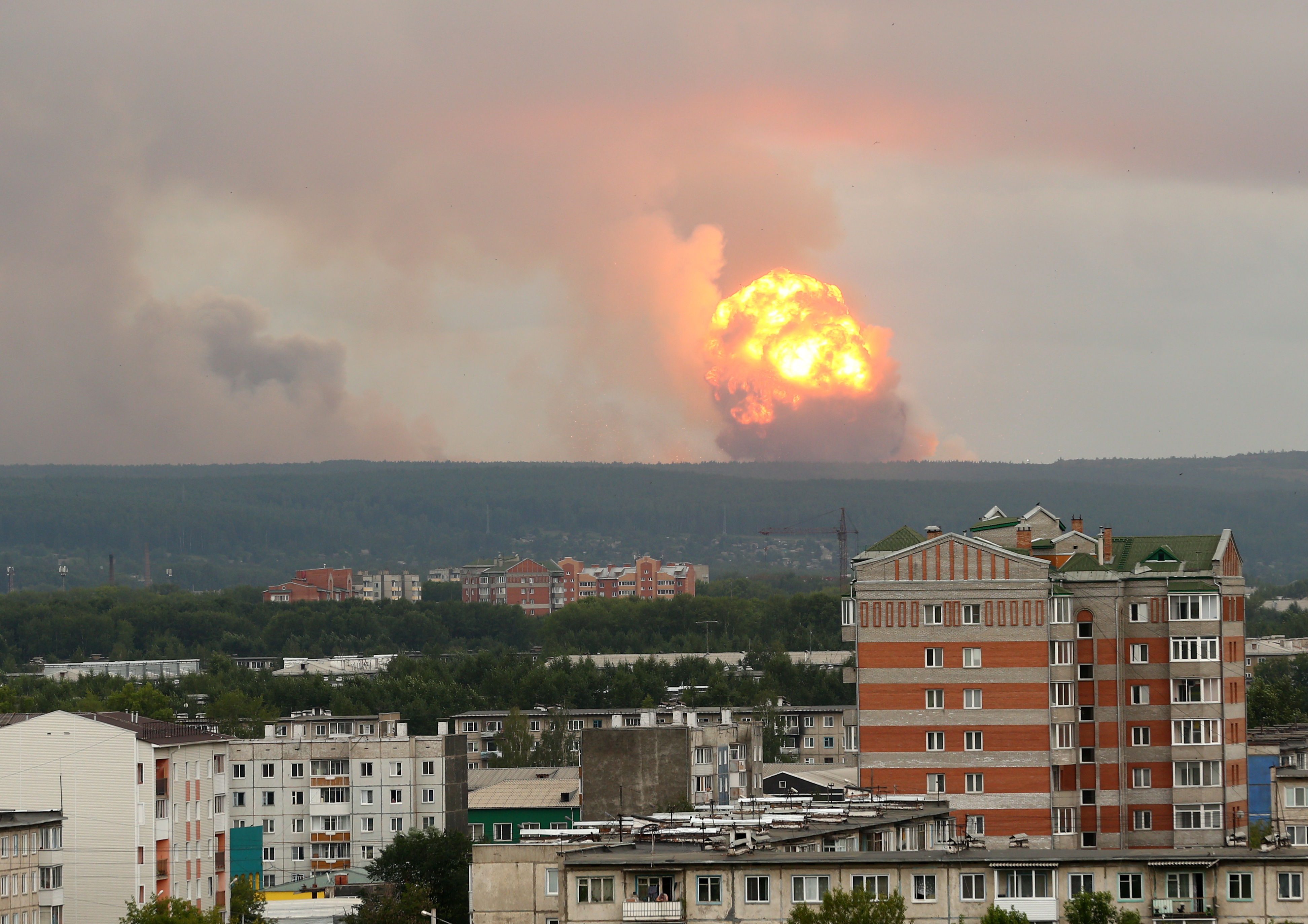 epa07758758 Explosions of a military ammunition depot some six miles away from a city of Achinsk, Krasnoyarsk area, 05 August 2019, issued 06 August 2019. Reports by the Emergenicies Ministry stating about 12 people were injured during the explosions.  EPA/DMITRY DUB