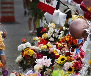 epa07759594 A little girl pauses to look at flowers at the make shift memorial after the mass shooting that happened at a Walmart in El Paso, Texas, 06 August 2019. Twenty two people were killed and 26 injured during a mass shooting at the Walmart on 03 August 2019. Prosecutors said they will seek the death penalty against Patrick Crusius, a 21-year-old man, accused of the mass shooting.  EPA/LARRY W. SMITH
