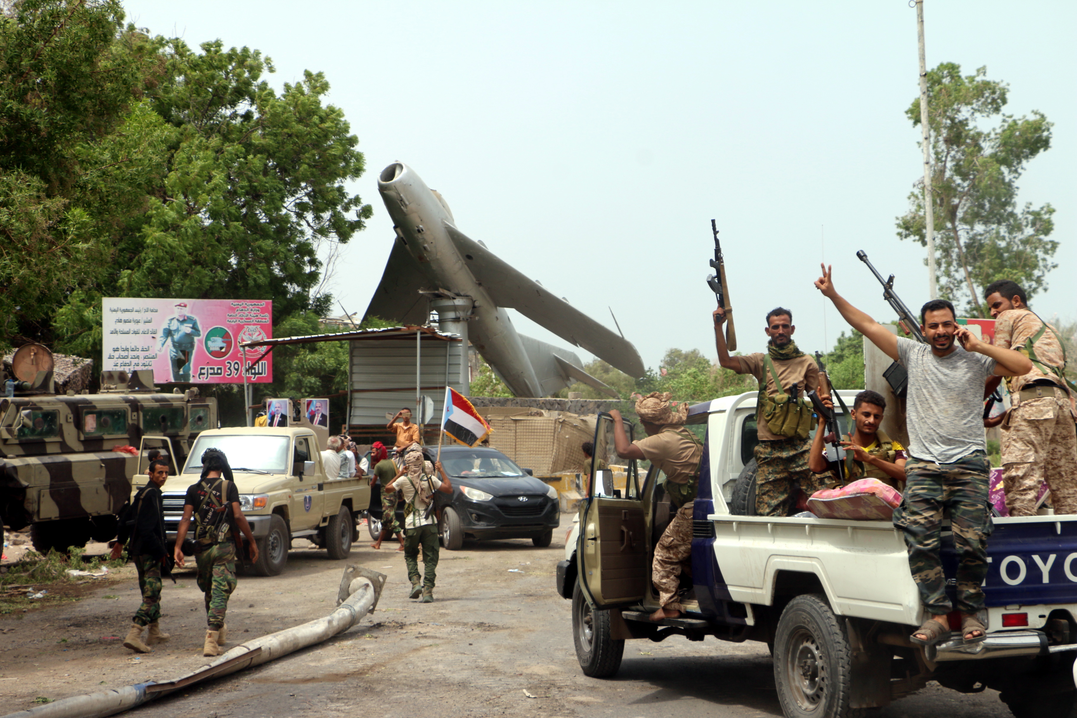 epa07766720 Armed members of a separatist southern group celebrate after seizing a military base during clashes with government forces in the southern port city of Aden, Yemen, 10 August 2019. According to reports, separatist forces in southern Yemen, backed by the United Arab Emirates, have seized all military bases belonging to the Saudi-backed Yemeni government in the southern city of Aden after four days of fighting between the two sides.  EPA/NAJEEB ALMAHBOOBI