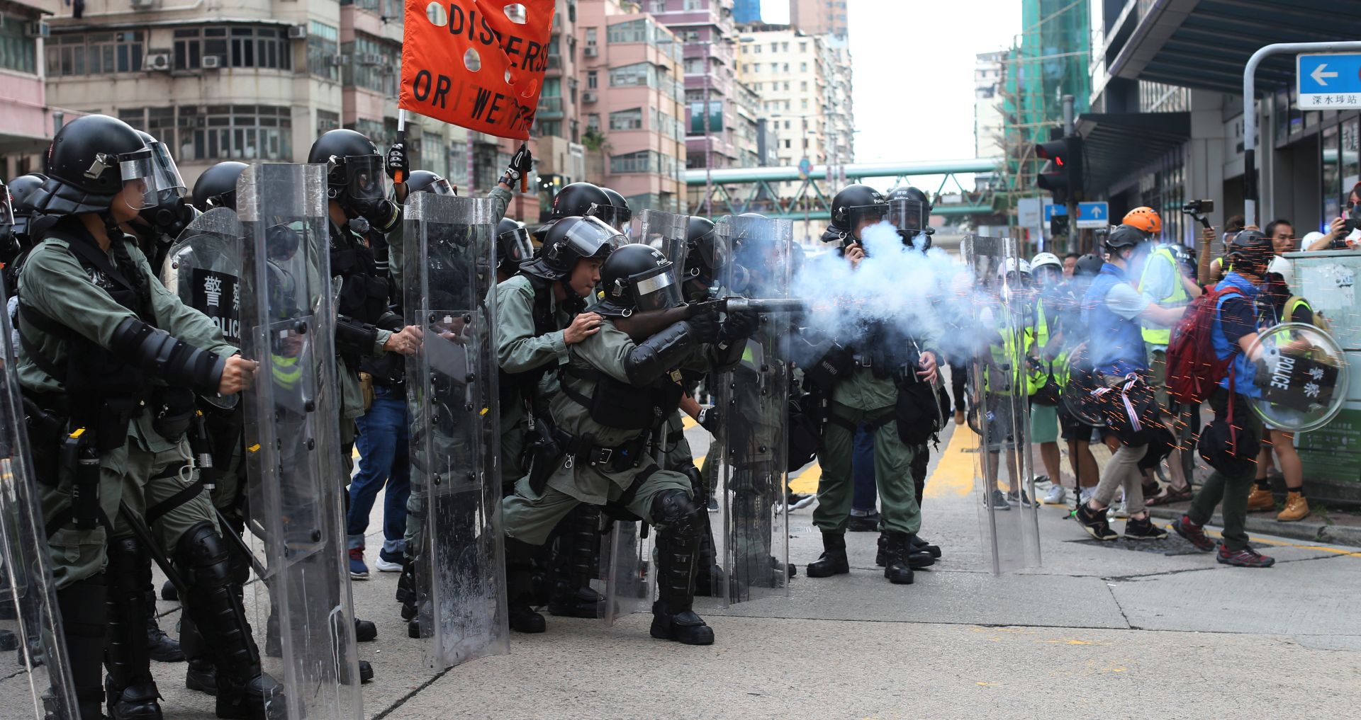 epa07767829 Riot police fire tear gas at anti-government protesters during a rally in Sham Shui Po, Hong Kong, China, 11 August 2019. Hong Kong has been gripped for weeks by mass protests, which began in June 2019 over a now-suspended extradition bill to China and have developed into an anti-government movement.  EPA/JEROME FAVRE