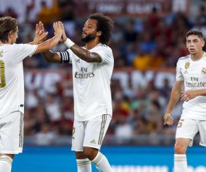 epa07768781 Real Madrid's Marcelo (C) jubilates with his teammate Luka Modric (L) after scoring the 0-1 goal during the international friendly soccer match AS Roma vs Real Madrid CF at Olimpico stadium in Rome, Italy, 11 August 2019.  EPA/ANGELO CARCONI