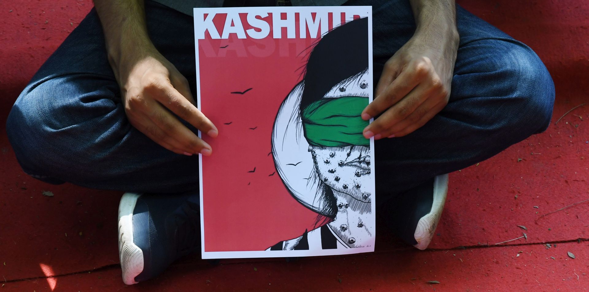 epa07764113 An activist holds a placard as he takes part in a demonstration to condemn the scrapping of Article 370 that granted a special status to Jammu and Kashmir, by the Indian government, in New Delhi, India, 09 August 2019. Indian government on 05 August moved a resolution in the parliament that removes the special constitutional status granted to the disputed Kashmir region. The Indian-administered Kashmir region has been under heavy lockdown with a restriction on public gatherings. Kashmir has been a disputed region since 1947 when India and Pakistan won their freedom from British rule.  EPA/STR