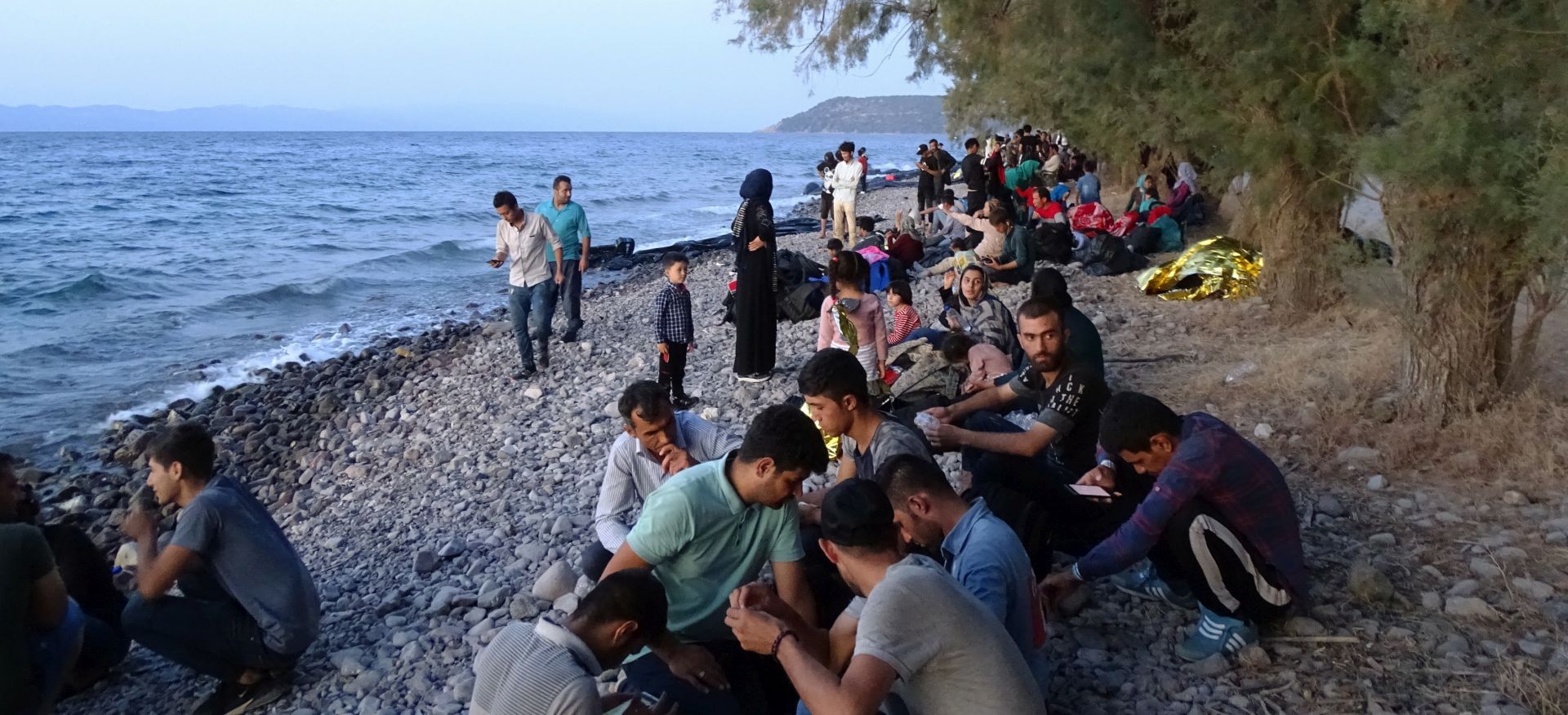 epa07803513 Migrants, who arrived on 13 boats, at Skala Sikamias, Lesvos Island, Greece, 29 August 2019 (issued 30 August 2019). A total of 547 people landed on the island, including 177 men, 124 women and 246 children. Of these, 193 were transferred to the Moria Reception and Identification Center and the rest remained at the UNHCR camp in Sykamia, the so-called 'stage 2' camp, with the prospect of being transferred to Moria for registration on 30 August. According to reports, two Coast Guard vessels are operating in the area.  EPA/STRATIS BALASKAS