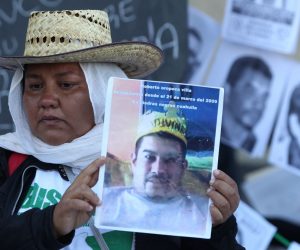 epa07804851 A woman shows a picture of a missing person in front of the National Palace, in Mexico City, Mexico, 30 August 2019.Relatives of missing people also plan to deliver 80.000 signings to demand to the Government better search protocols. At the same time Mexico's President Andres Manuel Lopez Obrador informed that authorities found 4974 bodies in 3024 clandestine graves between 2006 and mid-August 2019.  EPA/Mario Guzmán