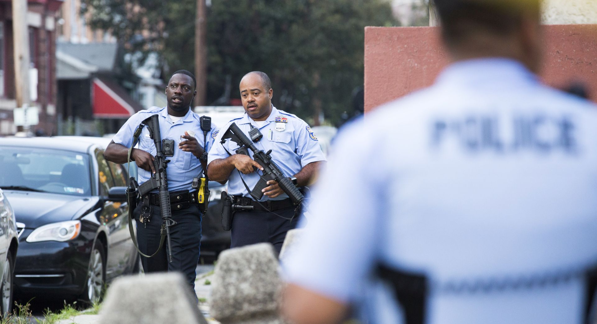 epaselect epa07773958 Police with automatic rifles walk away from the intersection of 15th Street and W Erie Avenue during an active police shooting in Philadelphia, Pennsylvania, USA, 14 August 2019. A suspect shot at least five Philadelphia police officers, with gunfire continuing for more than one hour. One suspect is in custody and a second suspect is under SWAT surveillance in a house near the intersection of 15th Street and W Erie Ave.  EPA/STRINGER