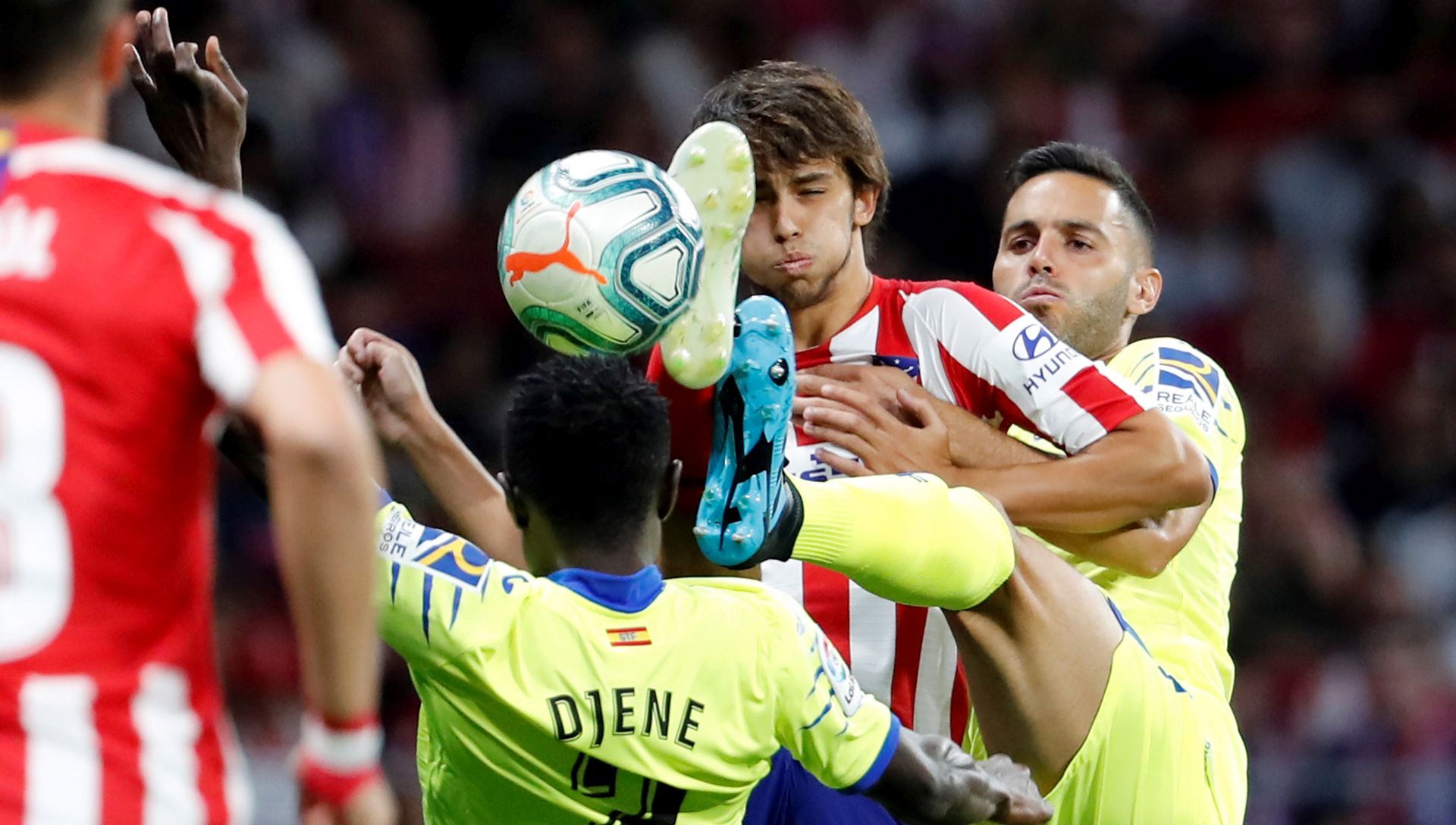 epa07779887 Atletico Madrid's Portuguese forward Joao Felix (2-R) vies for the ball with Getafe CF's Togolese defender Djene Dakoman (2-L) during their LaLiga game at Wanda Metropolitano Stadium in Madrid, Spain, 18 August 2019.  EPA/Chema Moya