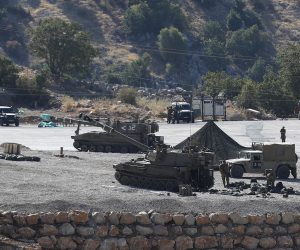 epa07792051 Israeli soldiers with their artillery unit deployed at the Israeli-Syrian border, in the Golan Heights, north of Israel, 25 August 2019. The Israel Defense Forces (IDF) confirmed on the day that overnight its Air Force had struck Iranian Quds Force targets in Syria. In reactions to the incident, the Israeli deployed artillery units and the Iron Dome at the border with Syria.  EPA/ATEF SAFADI