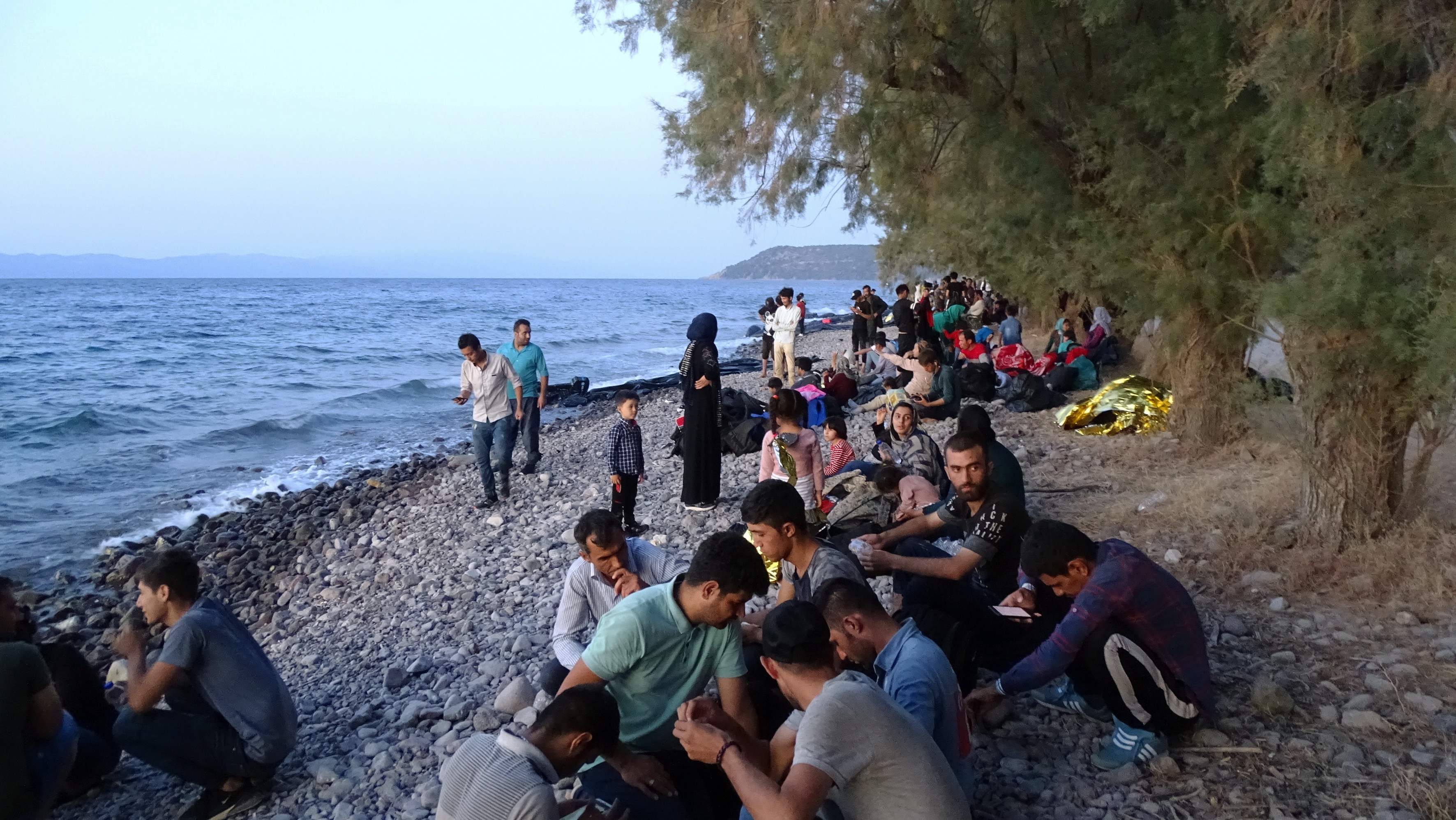 epa07803513 Migrants, who arrived on 13 boats, at Skala Sikamias, Lesvos Island, Greece, 29 August 2019 (issued 30 August 2019). A total of 547 people landed on the island, including 177 men, 124 women and 246 children. Of these, 193 were transferred to the Moria Reception and Identification Center and the rest remained at the UNHCR camp in Sykamia, the so-called 'stage 2' camp, with the prospect of being transferred to Moria for registration on 30 August. According to reports, two Coast Guard vessels are operating in the area.  EPA/STRATIS BALASKAS
