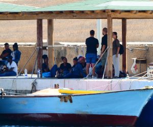 epa07812881 Migrants wait to diembark from a boat in Lampedusa harbour, Lampedusa, Italy, 02 September 2019. The three boats with a total of 143 migrants on board arrived in Lampedusa on 02 September 2019.  EPA/Elio Desiderio