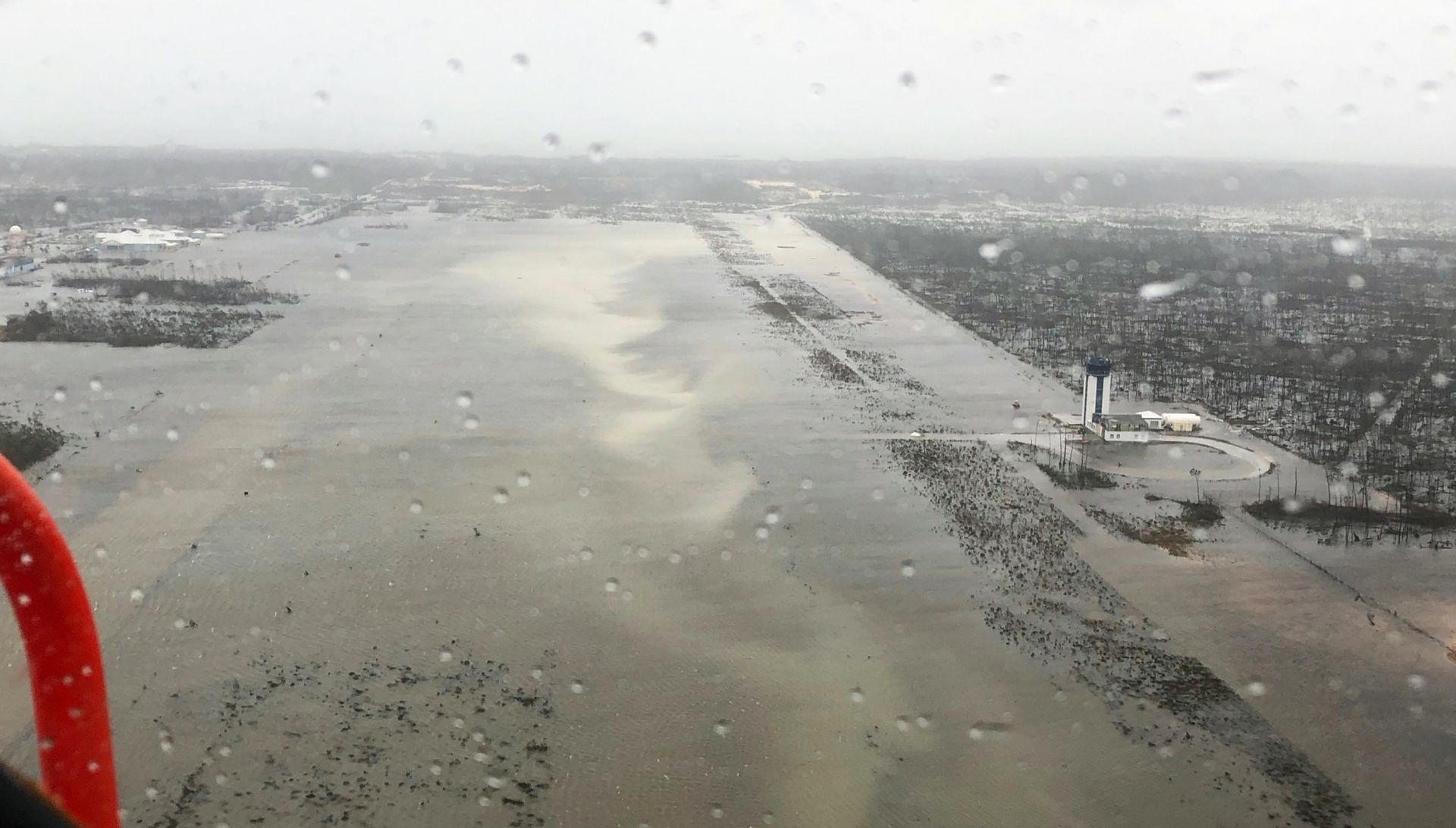 epa07814893 A handout aerial view taken by Coast Guard Air Station Clearwater forward-deployed four MH-60 Jayhawk helicopter crew in support of search and rescue and humanitarian aid in the Bahamas, 02 September 2019, showing heavy flooding in low lying areas at the Bahamas after hurricane Dorian hit the islands. As Hurricane Dorian slowly makes its way across the Bahamas, it has according to US National Hurricane Center (NHC) become stationary, moving merely some 20 km in one day, as it continues to leash heavy rains and wind, creating storm surges on the islands.  EPA/Petty Officer 3rd Class HUNTER MEDLEY/US COAST GUARD HANDOUT  HANDOUT EDITORIAL USE ONLY