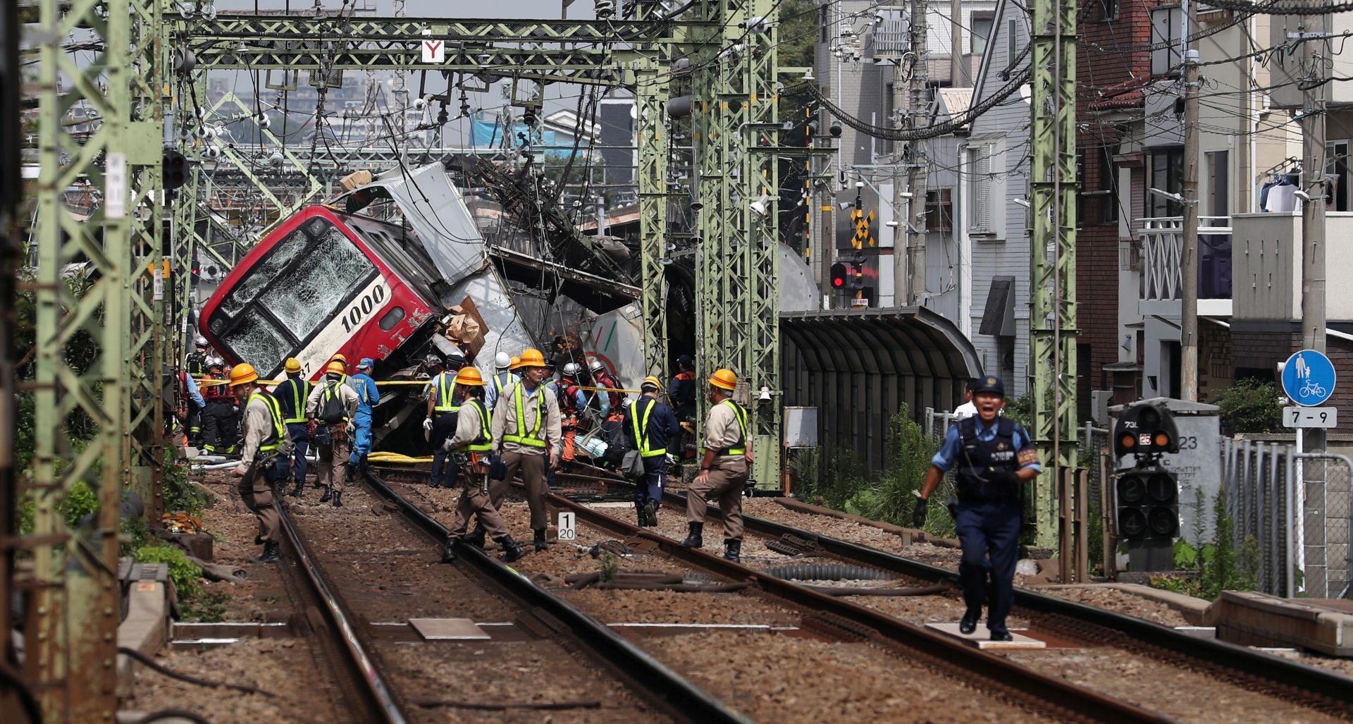 epa07818285 Rescuers and workers gather next to a train after it collided with a truck at a rail crossing in Yokohama, near Tokyo, Japan, 05 September 2019. According to media reports, about 33 people were injured in the collision.  EPA/JIJI PRESS JAPAN OUT EDITORIAL USE ONLY/  NO ARCHIVES