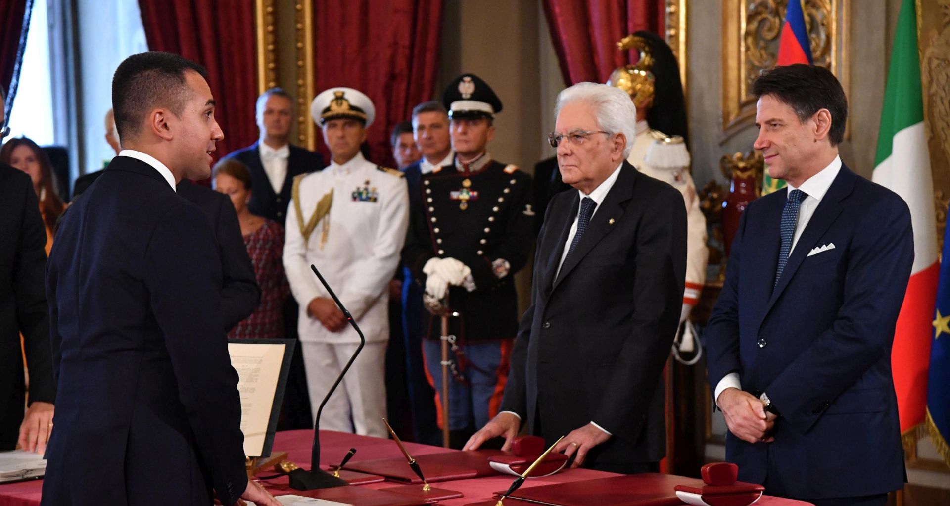 epa07818661 Italian Minister of Foreign Affairs Luigi Di Maio (L) stands in front of Italian Premier Giuseppe Conte (R) and President Sergio Mattarella (C) during the new government's swearing-in at Quirinal Palace, Rome, Italy, 05 September 2019. Italian Prime Minister Giuseppe Conte's new government is a coalition between the anti-establishment 5-Star Movement (M5S) and the center-left Democratic Party (PD) that will have 21 ministers, 10 from the M5S, nine from the PD and one from the small leftwing Free and Equal (LeU) party, media reported.  EPA/ALESSANDRO DI MEO