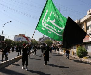 epa07832398 Iraqi Shiite men carry religious flags during the Ashura festivals at Karada district, in central Baghdad, Iraq, 10 September 2019. The Ashura day commemorates the death anniversary of the third Shiite Imam Hussein, who was grandson of Muslim Prophet Muhammed. Ashura is the peak of ten days of mourning when Shiite Muslims mourn the killing of Imam Hussein whose shrine is in Karbala in southern Iraq.  EPA/AHMED JALIL