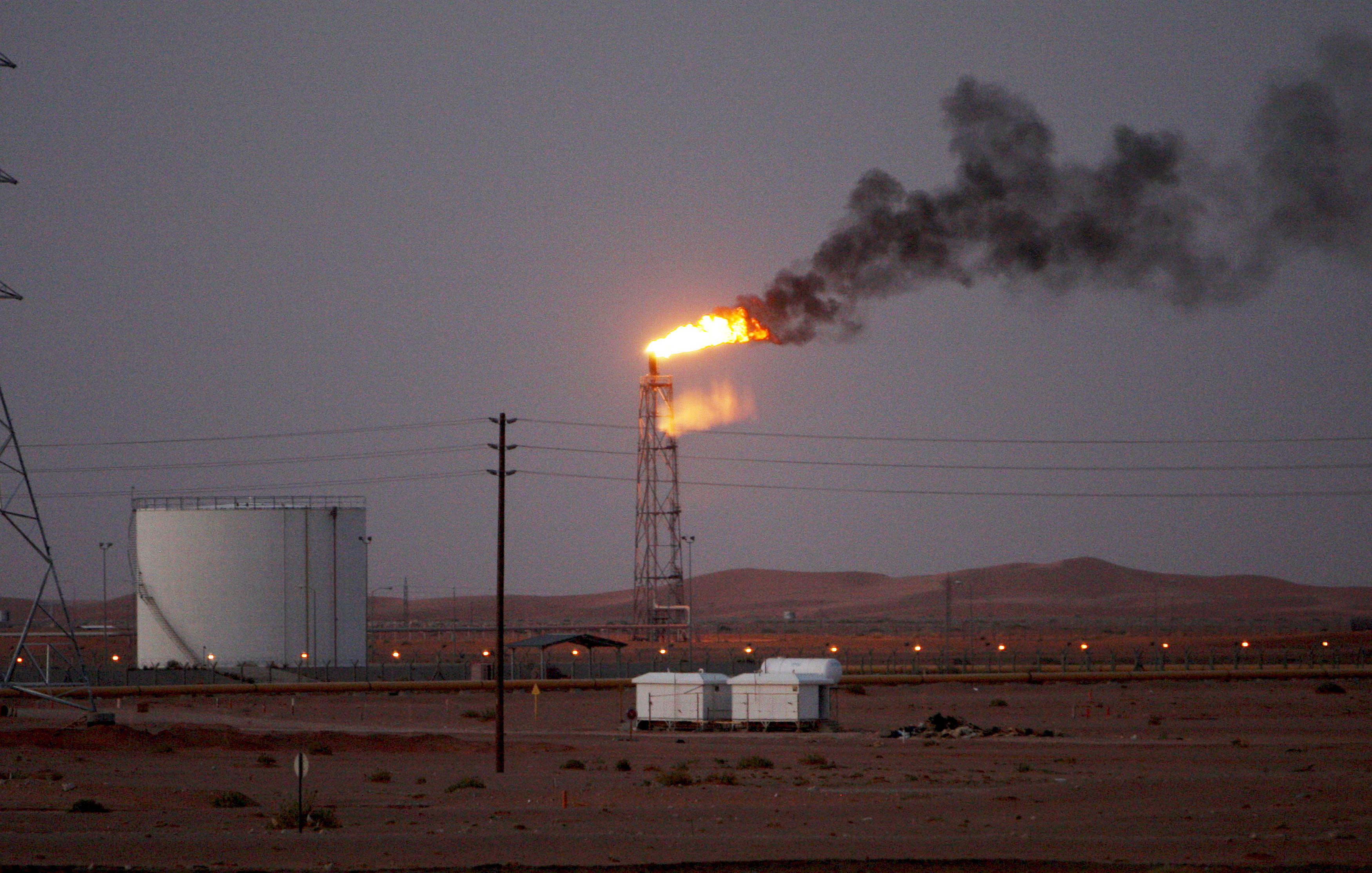 epa07841156 (FILE) - A gas flame behind pipelines in the desert at Khurais oil field, about 160 km from Riyadh, Kingdom of Saudi Arabia, 23 June 2008 (reissued 14 September 2019). According to Saudi state-owned oil company Aramco, two of its oil facilities in Saudi Arabia, Khurais and Abqaiq, were set on fire after allegedly having been targeted by drone attacks.  EPA/ALI HAIDER *** Local Caption *** 55191226