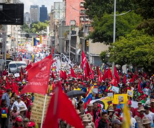 epa07860287 Supporters of the Venezuelan government take part in a march to deliver a petition with 13 million signatures denouncing the US blockade on Venezuelan state goods to the Vice presidency of the country, in Caracas, Venezuela, 21 September 2019. Vice President Delcy Rodriguez said that she will denounce the alleged connection of the head of the National Assembly Juan Guaido with the Colombian criminal group 'Los Rastrojos' to the United Nations, where she will also carry more than petition with 13 million signatures.  EPA/MIGUEL GUTIERREZ