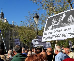 epa07865490 Protesters hold a banner with a picture of Spanish late dictator Francisco Franco (R) and German late dictator Adolf Hitler (L) that reads 'Their people also died because of their fault' during a protest at the Supreme Court in Madrid, Spain, to support the Government's decision of exhuming Franco's remains. The Supreme Court has endorsed a Royal Decree passed by the socialist Government, 24 August 2018, to modify the Spanish Historic Memory Law in order to allow the exhumation of Spanish dictator Francisco Franco's body from the memorial. El Valle de los Caidos is a controversial memorial complex that Franco decided to build back in 1940 to bury soldiers of the Nationalist faction fallen during the Civil War. It was years later, before its opening, when it was decided that soldiers from both sides should be buried at the memorial that was finally finished in 1959. Franco has been buried at the memorial since his death in 1975. According to the Supreme Court's ruling, Franco will have to be buried in a cemetery near Madrid, against his family's will that had the intention of burying him in the Spanish capital's city center.  EPA/Fernando Alvarado