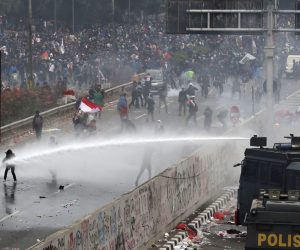 epa07865954 Indonesian riot police officers use a water cannon during clashes with students following a protest outside the parliament building in Jakarta, Indonesia, 24 September 2019. Thousands of students staged protests across the country against new law that proposed change in its criminal code laws and weaken the country's anti-corruption commission.  EPA/MAST IRHAM
