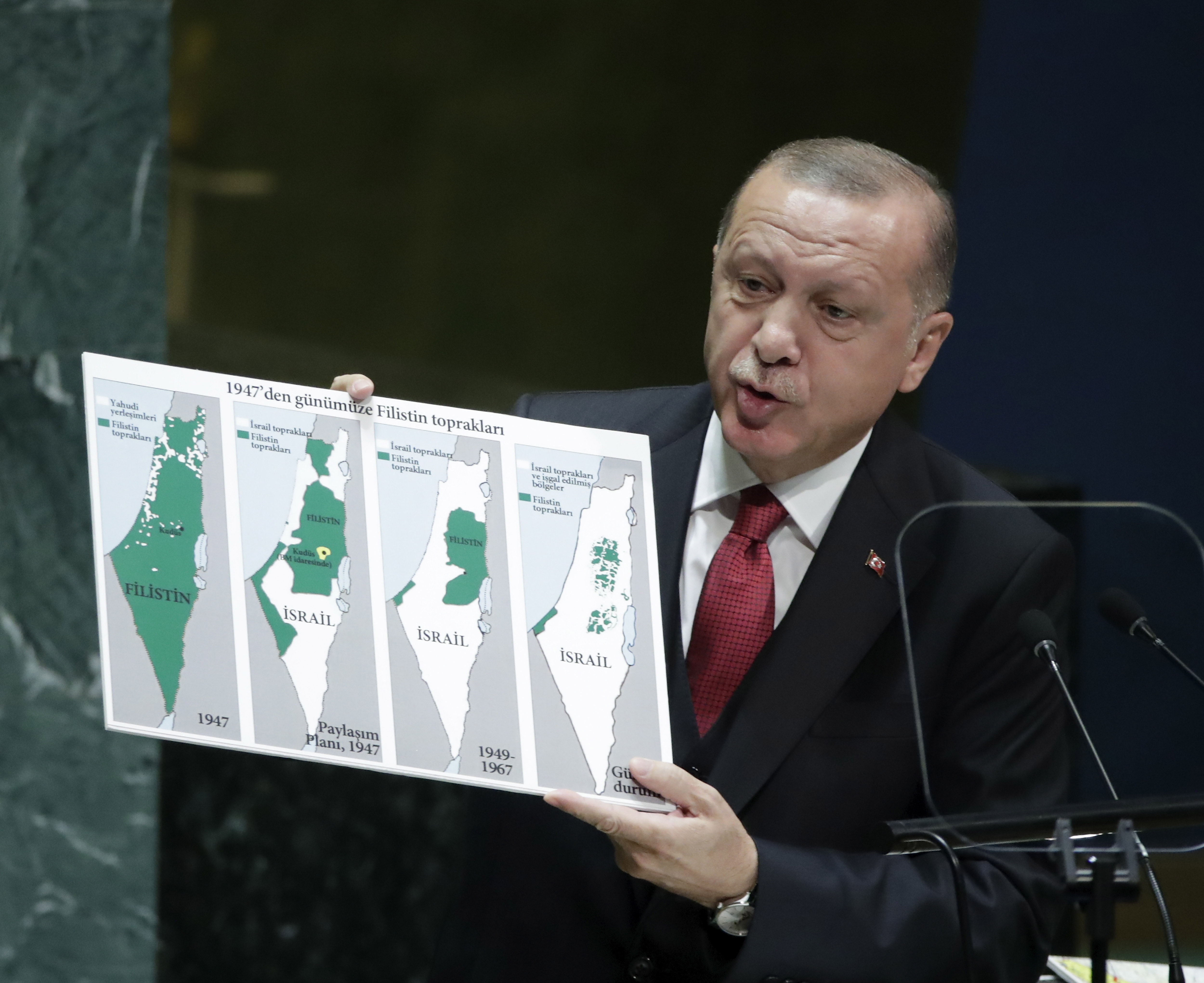 epa07866584 Turkish President Recep Tayyip Erdogan, holds a map showing the evolution of Israel and Palestinian state from 1947 as he addresses the general debate of the 74th session of the General Assembly of the United Nations at United Nations Headquarters in New York, New York, USA, 24 September 2019. The annual meeting of world leaders at the United Nations runs until 30 September 2019.  EPA/JASON SZENES
