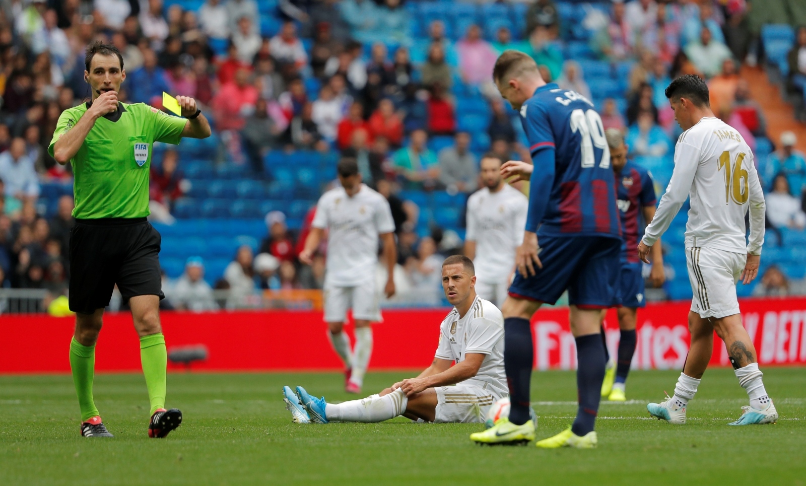 La Liga Santander - Real Madrid v Levante Soccer Football - La Liga Santander - Real Madrid v Levante - Santiago Bernabeu, Madrid, Spain - September 14, 2019  Real Madrid's Eden Hazard looks on as Levante's Carlos Clerc is shown a yellow card by referee Ricardo de Burgos Bengoetxea  REUTERS/Susana Vera SUSANA VERA