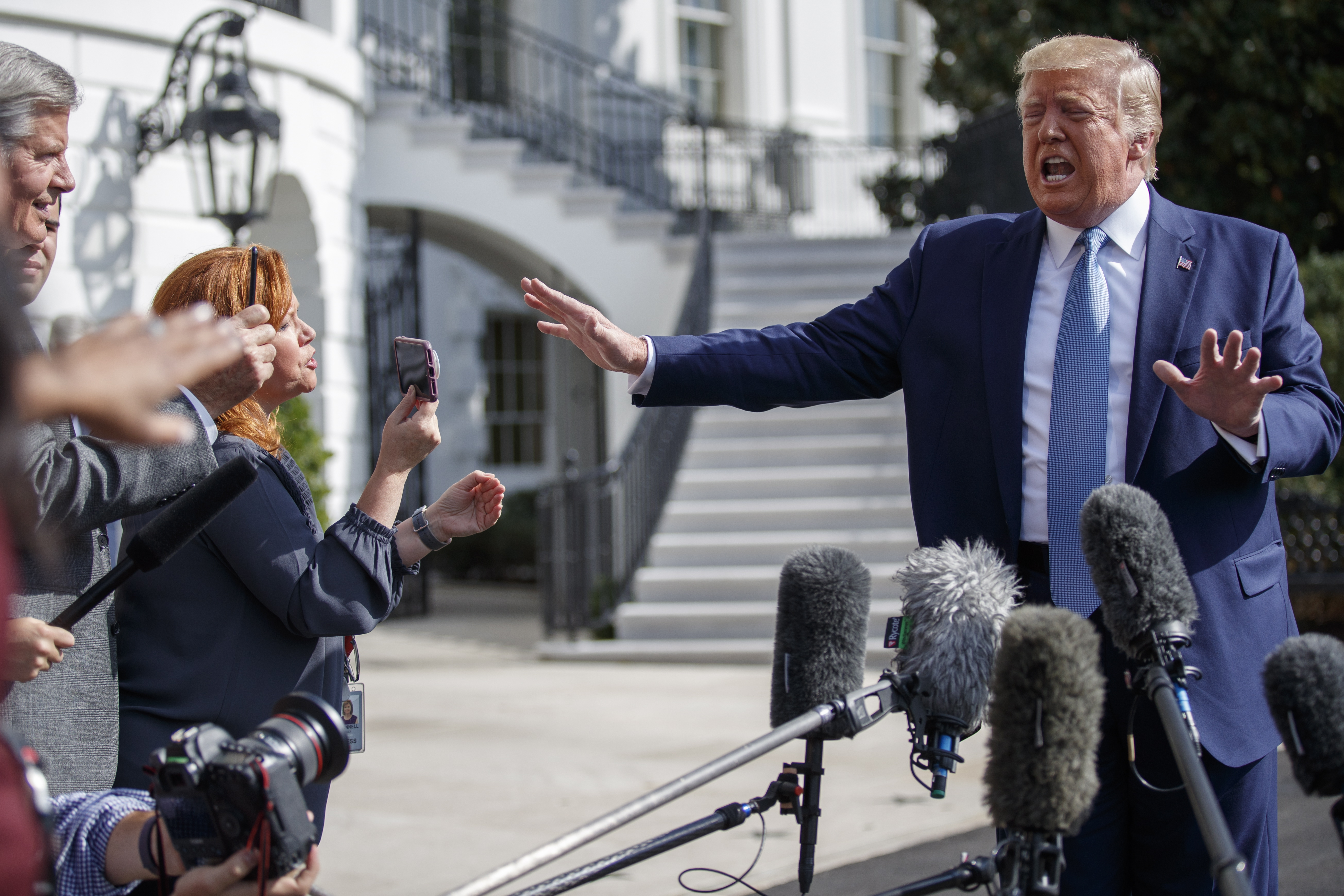 epa07895446 US President Donald J. Trump responds to a question from the news media as he walks to board Marine One on the South Lawn of the White House in Washington, DC, USA, 04 October 2019. President Trump is traveling to Walter Reed National Military Medical Center to visit wounded service members and award five Purple Heart medals.  EPA/SHAWN THEW