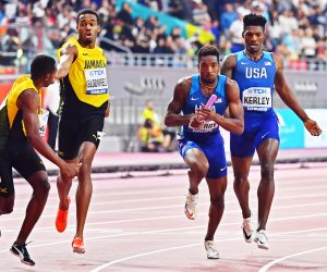 epa07902118 Fred Kerley (R) of the USA hands over to his teammate Michael Cherry (2-R) on their way to win the men's 4x400m Relay final at the IAAF World Athletics Championships 2019 at the Khalifa Stadium in Doha, Qatar, 06 October 2019. EPA/NOUSHAD THEKKAYIL