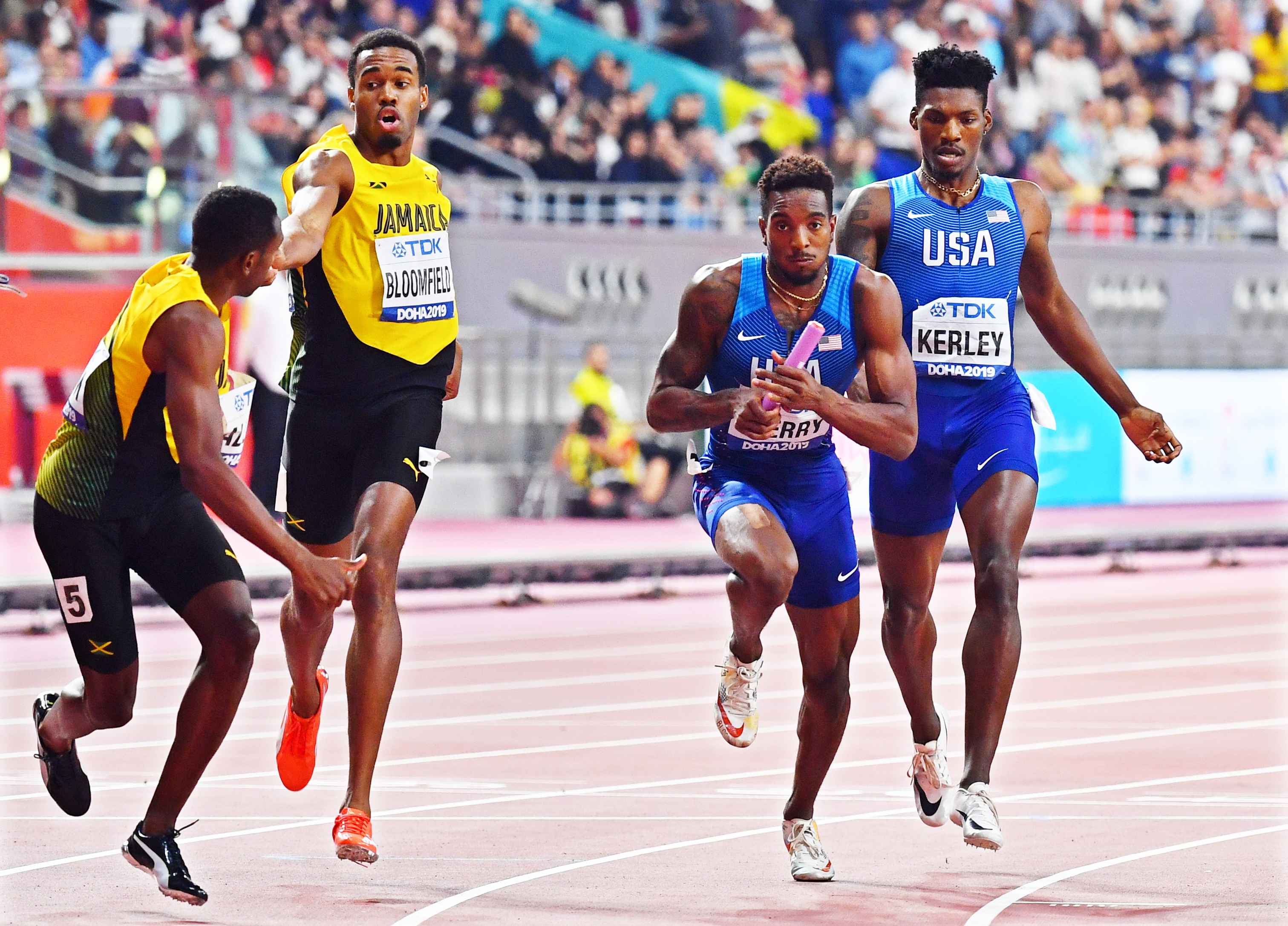 epa07902118 Fred Kerley (R) of the USA hands over to his teammate Michael Cherry (2-R) on their way to win the men's 4x400m Relay final at the IAAF World Athletics Championships 2019 at the Khalifa Stadium in Doha, Qatar, 06 October 2019. EPA/NOUSHAD THEKKAYIL