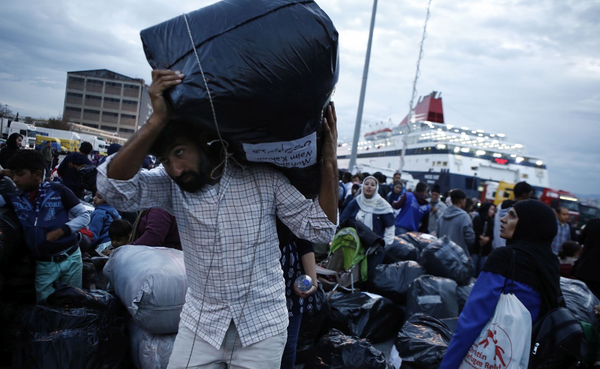 epa07902852 Migrants disembark from the ferry 'Nissos Samos' upon their arrival from Lesvos island to the port of Piraeus, Greece, 07 October 2019. The ferry arrived in Piraeus carrying 453 refugees and migrants from Moria, Lesvos and 13 from Chios Island, from the so-called vulnerable groups asking for asylum, who will be transferred to the village of Vagiohori, close to lake Volvi, in central Macedonia. The Moria reception and identification centre currently hosts 13,300 people, 1,000 of which are unaccompanied minors.  EPA/YANNIS KOLESIDIS