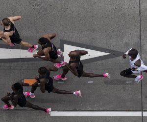 epaselect epa07914659 Eliud Kipchoge (in white), Kenyan marathon world record holder, in action next to his pacemakers during the INEOS 1:59 Challenge in Vienna, Austria, 12 October 2019. Kipchoge attempts to beat his own record becoming the first person to run a marathon in under two hours.  EPA/CHRISTIAN BRUNA