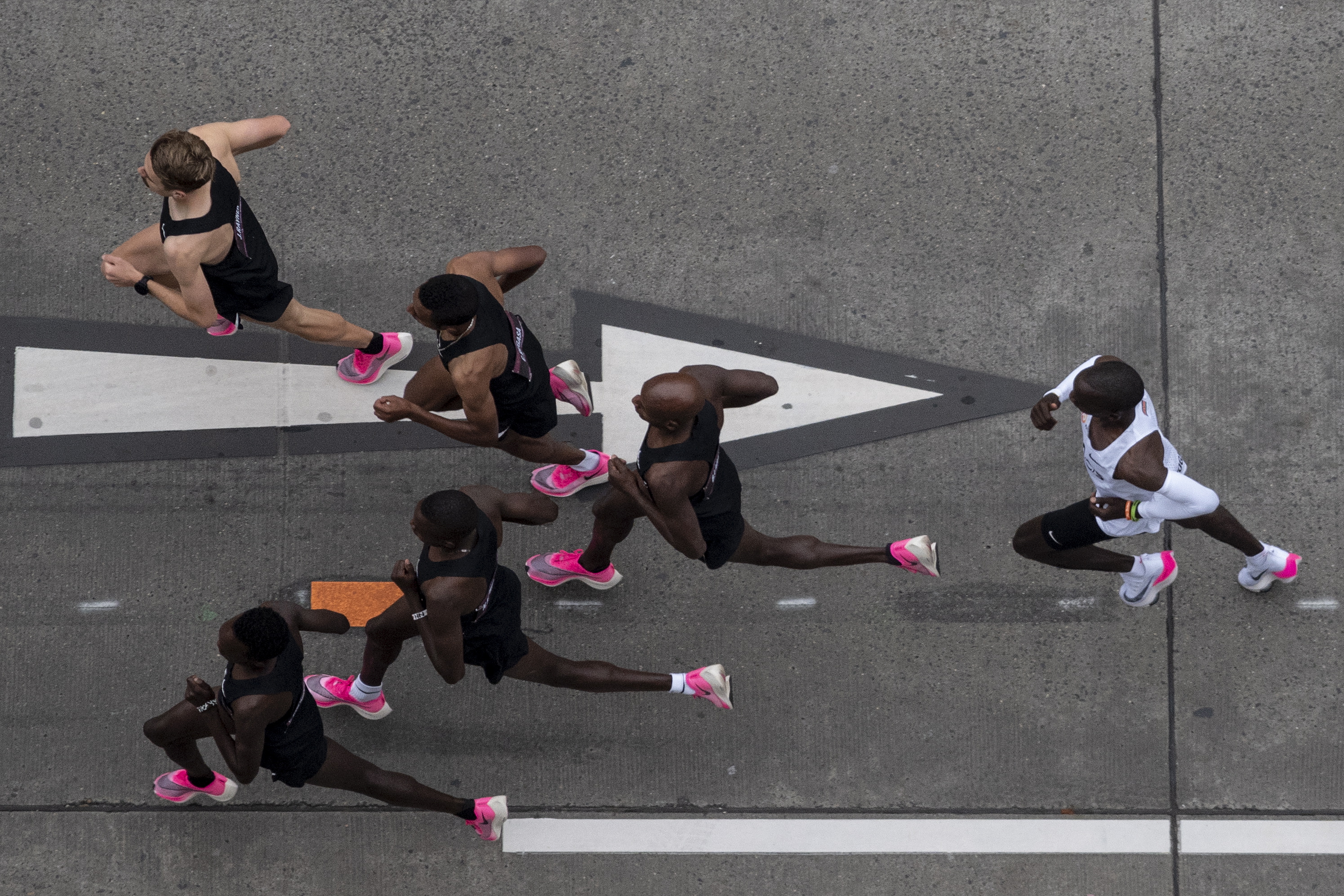 epaselect epa07914659 Eliud Kipchoge (in white), Kenyan marathon world record holder, in action next to his pacemakers during the INEOS 1:59 Challenge in Vienna, Austria, 12 October 2019. Kipchoge attempts to beat his own record becoming the first person to run a marathon in under two hours.  EPA/CHRISTIAN BRUNA