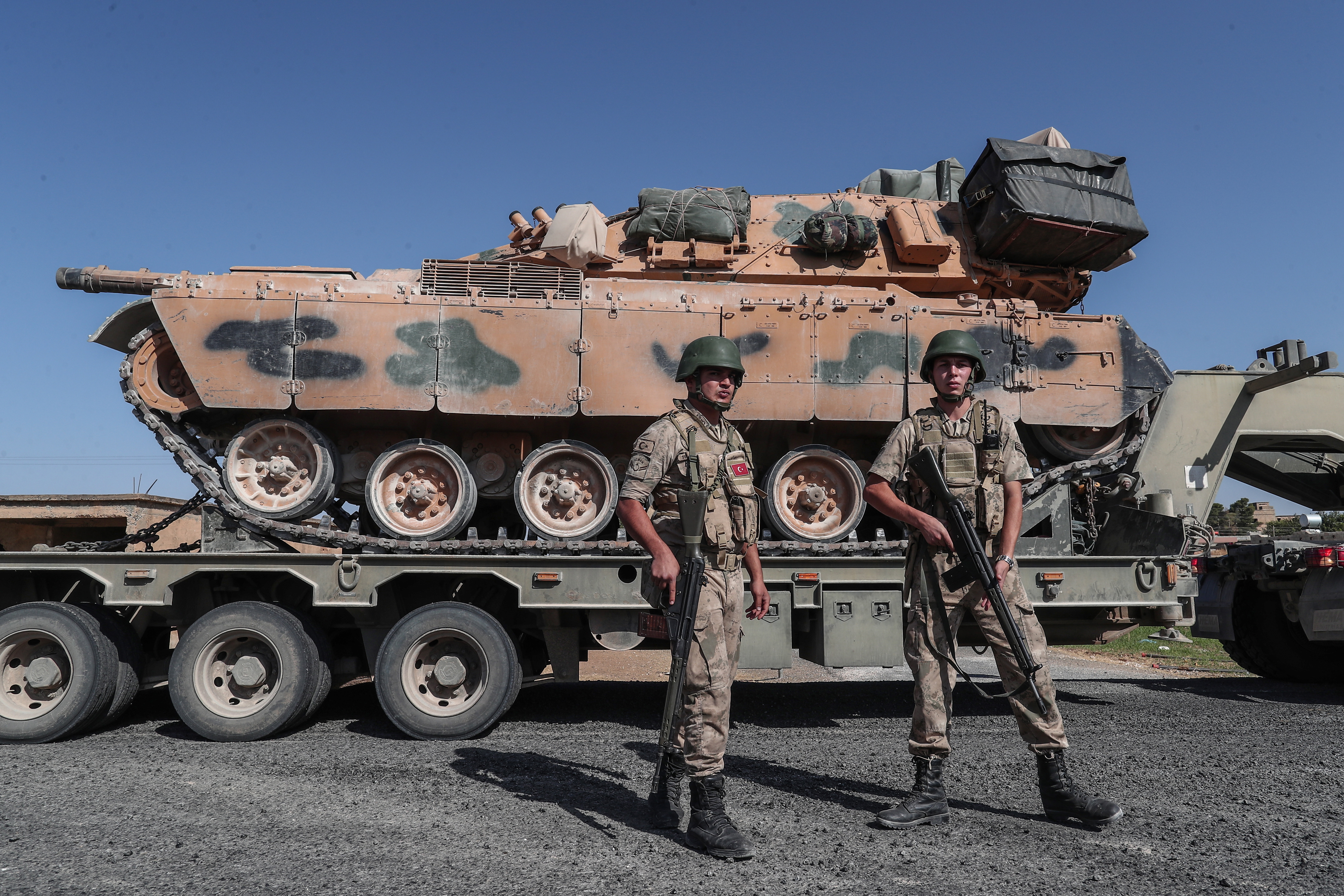 epa07914839 Turkish military vehicles carrying tanks as they are on the way to Northern Syria for a military operation in Kurdish areas, near the Syrian border, near Akcakale district in Sanliurfa, Turkey 12 October 2019. Turkey has launched an offensive targeting Kurdish forces in north-eastern Syria, days after the US withdrew troops from the area.  EPA/SEDAT SUNA
