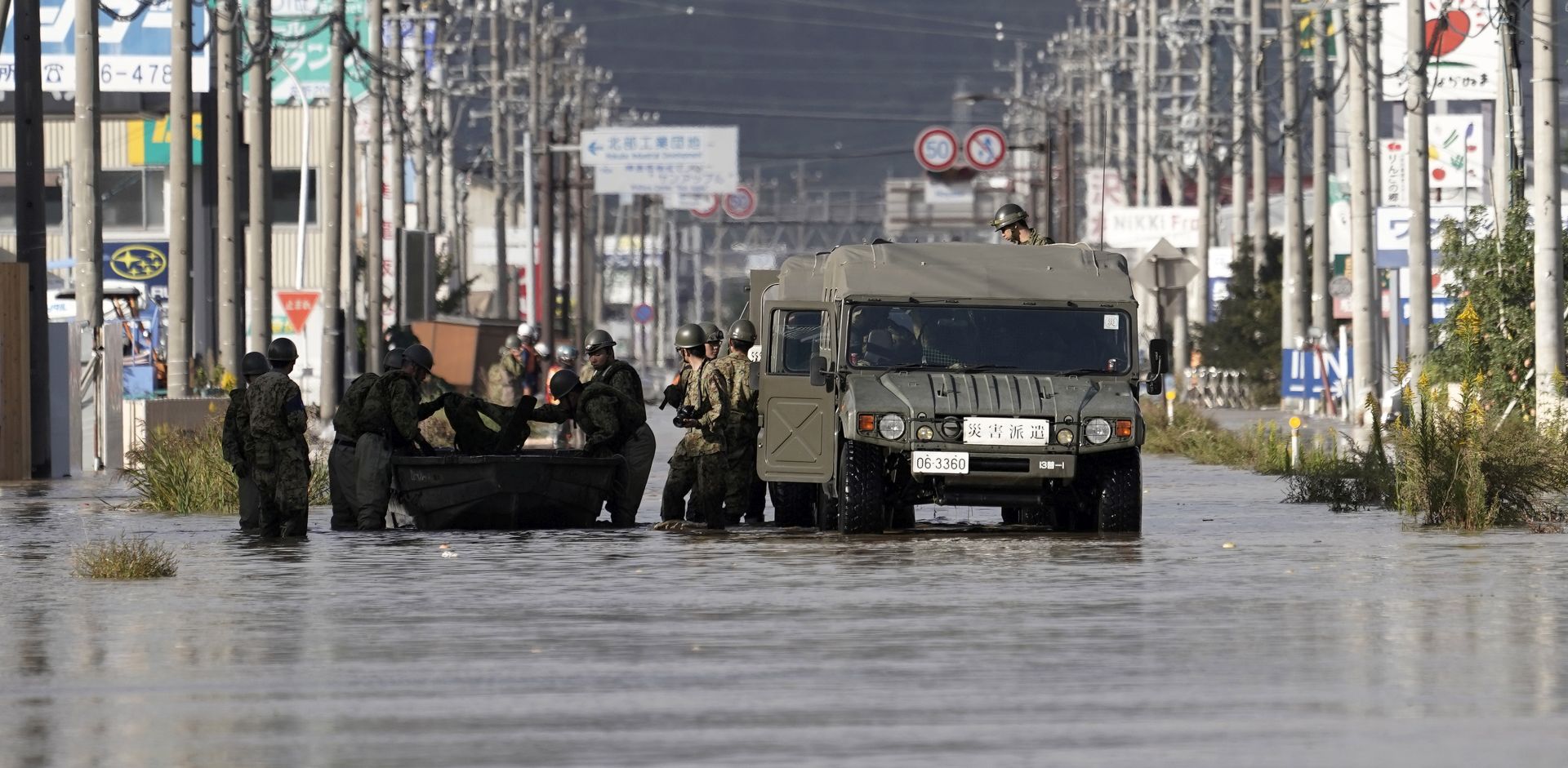 epa07917330 Japan's Self-Defense Force's vehicles and personnel prepare for a rescue operation at a  typhoon Hagibis flooded area in Nagano, Nagano Prefecture, central Japan, 13 October 2019. According to media reports, Tyhoon Hagibis has so far killed at least 26 people and injured more than 170, with some 18 still missing. The strongest typhoon of this season forced to suspend many railway services all over the country as well as cancelling about 1,600 domestic and international flights.  EPA/KIMIMASA MAYAMA
