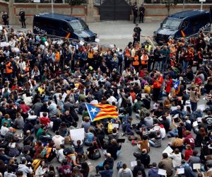 epa07938432 Protesters hold banners as they attend a sit-in protest outside Central Government's Headquarters in Catalonia, amid the visit of acting Spanish Prime Minister Sanchez, in Barcelona, Spain, 21 October 2019. The rally, called by the group Tsunami Democratic, is held in the framework of the Sanchez' s visit to the security forces officers who were admitted to hospitals in Barcelona after they were wounded in the riots in Barcelona. Catalonia region in Spain witnessed massive demonstrations and riots since the Spanish Supreme Court's 13 October ruling of prison terms against the Catalan political leaders accused of organizing the Catalan illegal referendum held in October 2017.  EPA/Toni Albir