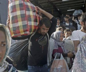 epa07940004 Migrants disembark from the ferry 'Paros Jet' upon their arrival from Samos Island at the port of Elefsina near Athens, Greece, 22 October 2019. Two ships carrying asylum seekers from the islands arrived at the port of Piraeus and Elefsina earlier this morning. The ferry 'Paros jet' carrying 700 asylum-seekers from Samos was guided to the port of Elefsina with the help of a pilot, from where they boarded coaches that took them to accomodation facilities on the mainland.  EPA/KOSTAS TSIRONIS