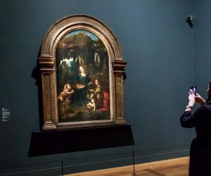 epa07940139 A visitor takes a picture of the painting  entitled 'The Virgin with a Child and Saint John the Baptist' by Italian Renaissance artist Leonardo Da Vinci during an exhibition at the Louvre Museum in Paris, France, 22 October 2019. The exhbition running from 24 October 2019 to 24 February 2020 marks the 500th anniversary of Da Vinci's death.  EPA/CHRISTOPHE PETIT TESSON