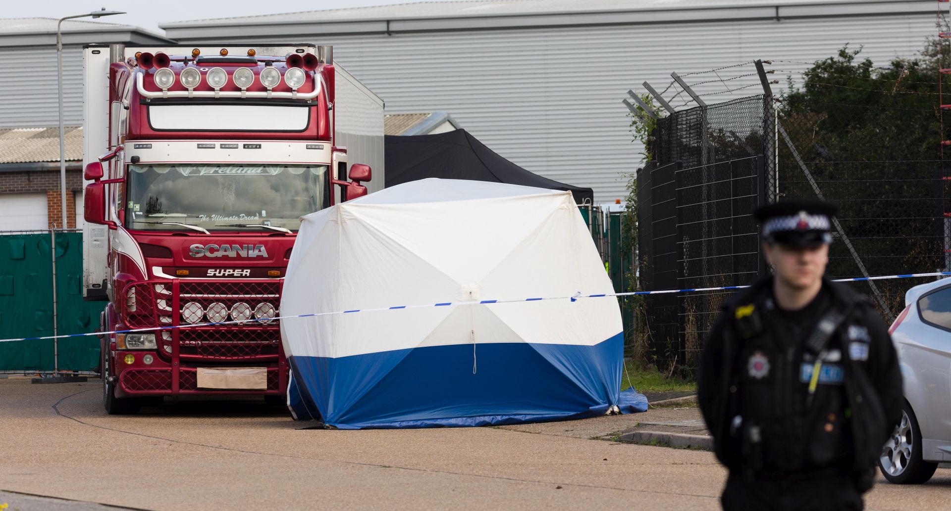 epa07943119 Police officers cordon off the area with the lorry at the scene in Waterglade Industrial Park in Grays, Essex, Britain, 23 October 2019. A total of 39 bodies were discovered inside a lorry container in the early hours of this morning, and pronounced dead at the scene.  EPA/VICKIE FLORES