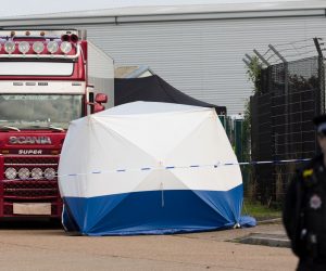 epa07943119 Police officers cordon off the area with the lorry at the scene in Waterglade Industrial Park in Grays, Essex, Britain, 23 October 2019. A total of 39 bodies were discovered inside a lorry container in the early hours of this morning, and pronounced dead at the scene.  EPA/VICKIE FLORES